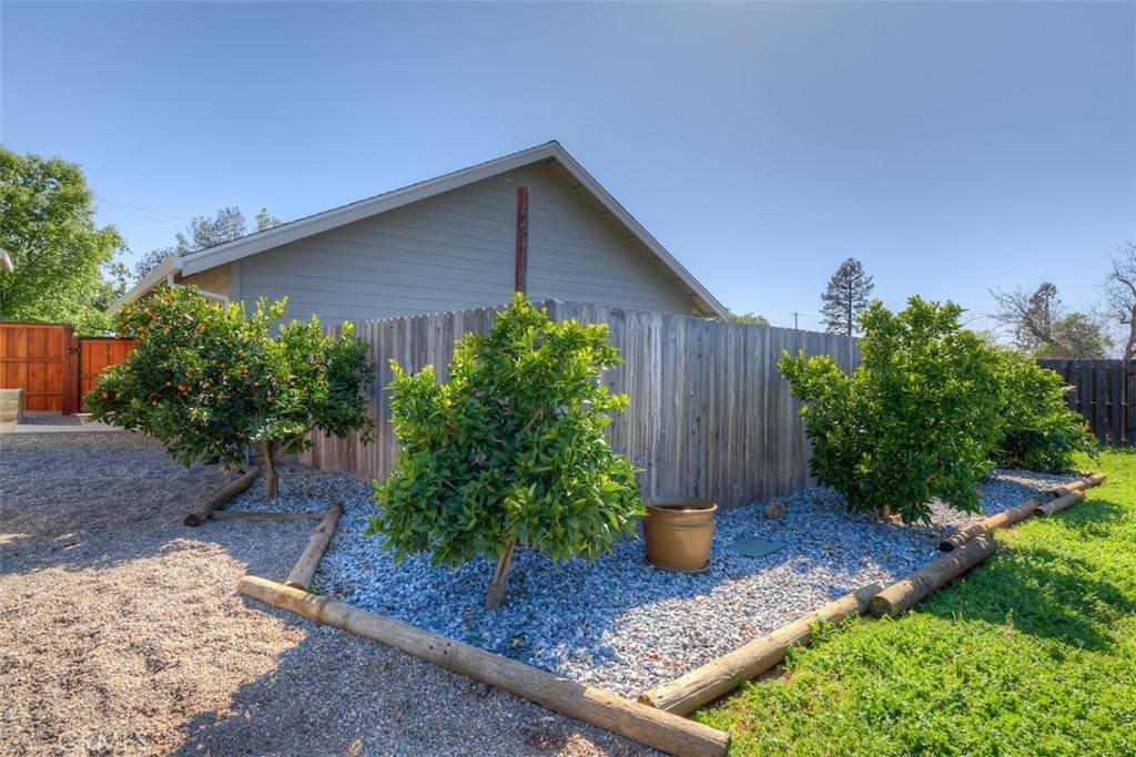 95 Sutter Road Paradise, CA 95969 - Photo 31 of 47 a view of a backyard with plants and a bench