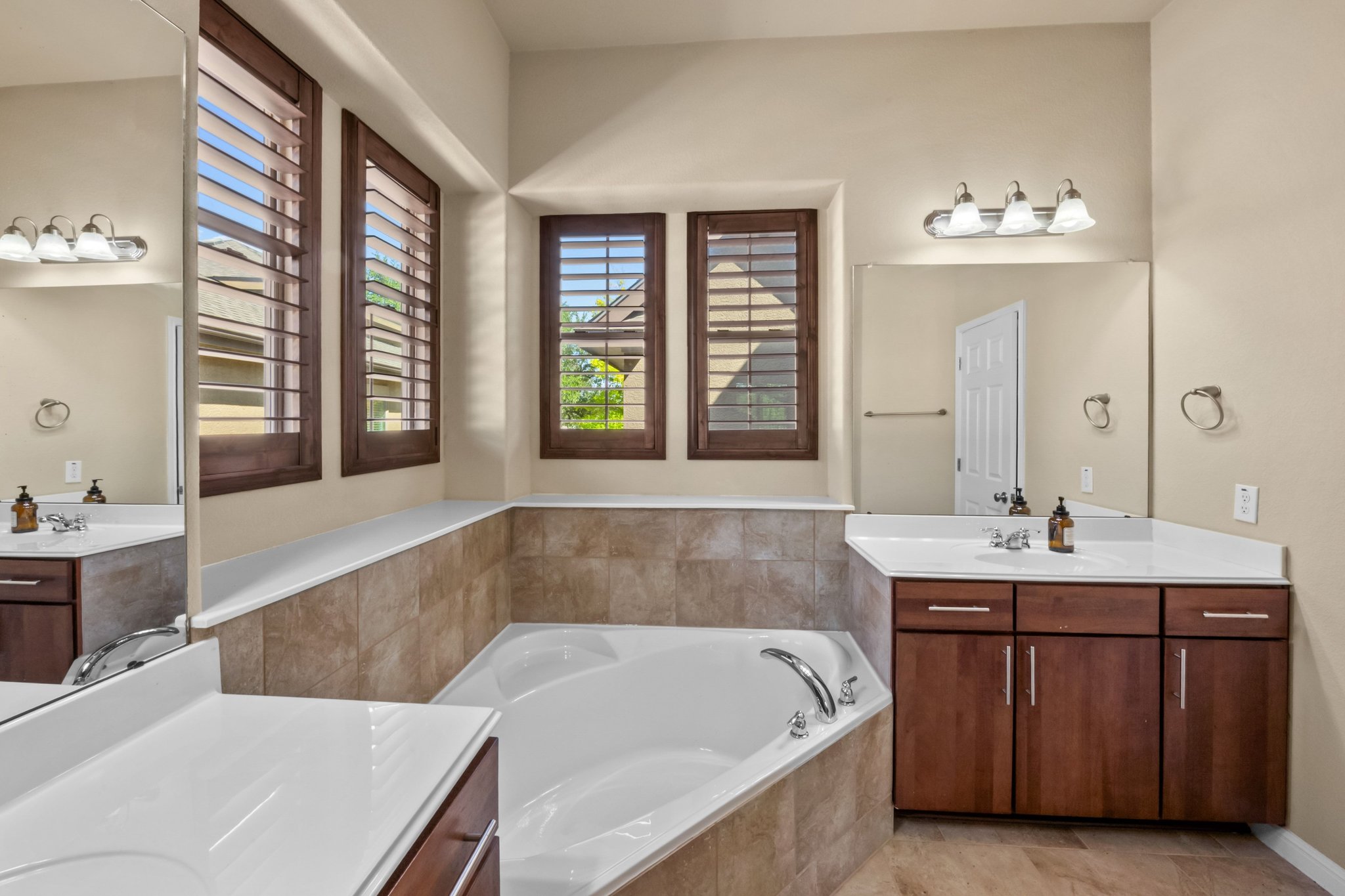 22204 Red Yucca Road Spicewood, TX 78669 - Photo 20 of 34 Full bathroom with two vanities and a bath