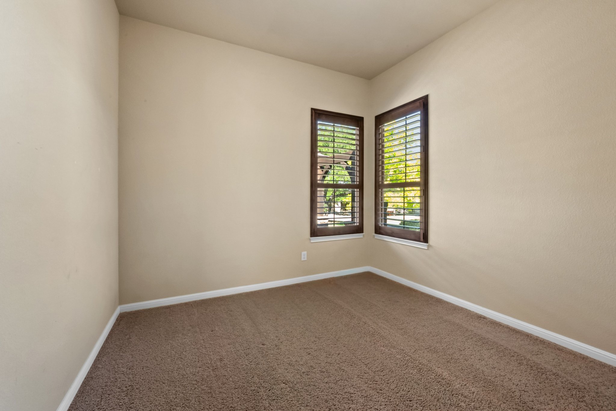 22204 Red Yucca Road Spicewood, TX 78669 - Photo 22 of 34 Carpeted spare room featuring baseboards