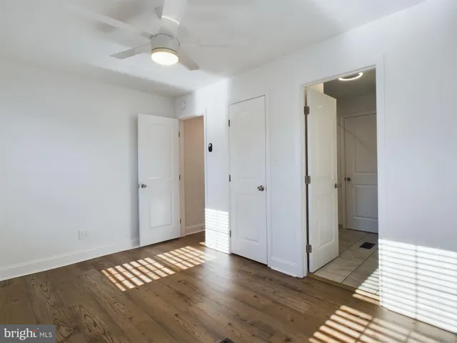 a view of a room with wooden floor and white walls