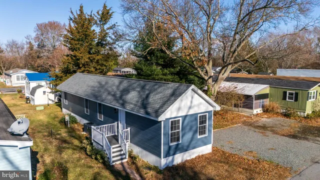 a view of a house with a yard balcony and tree