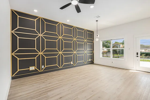 a view of kitchen with refrigerator and white cabinets