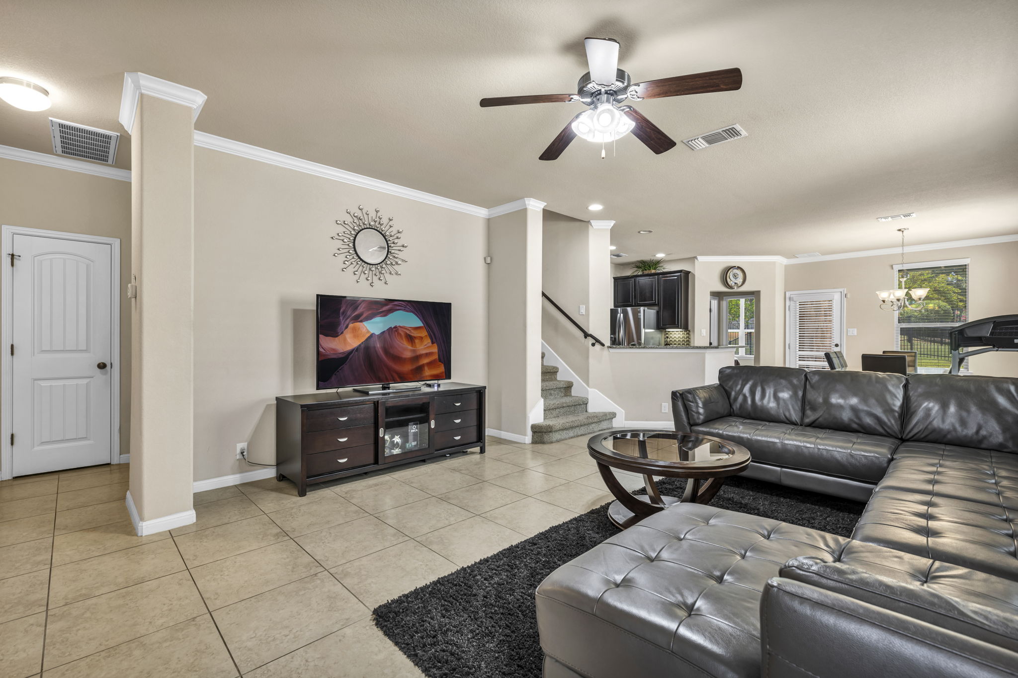 7320 Bandera Ranch Trail, Unit B Austin, TX 78750 - Photo 2 of 27 Living area featuring crown molding, tile patterned floors, ceiling fan, and hanging lights