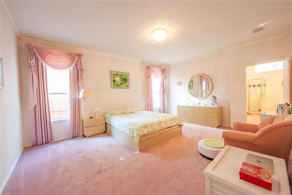 a spacious bedroom with a bed and a couch