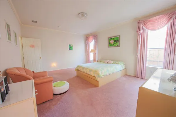 a spacious bedroom with a bed and a couch