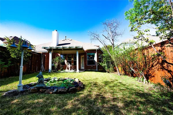 a front view of a house with a yard table and chairs