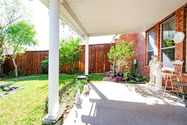 a view of backyard with swimming pool and green space