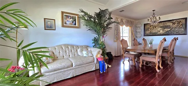 a living room with furniture and a chandelier