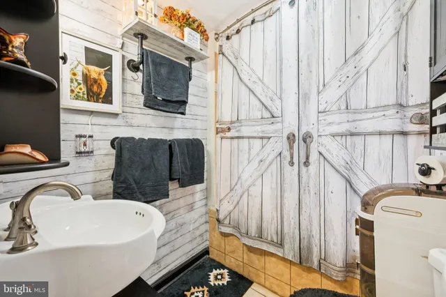 a view of roof deck with chair and wooden floor