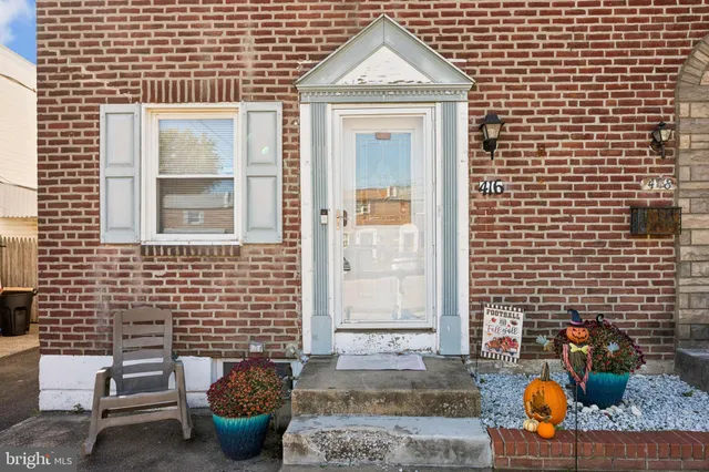 a front view of a house with outdoor seating