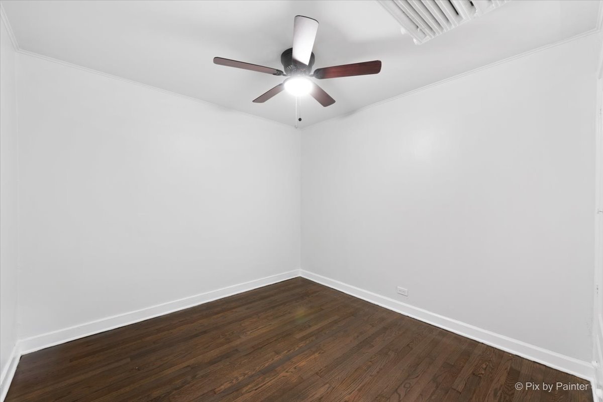 5428 North Campbell Avenue, Unit GS Chicago, IL 60625 - Photo 12 of 14 an empty room with wooden floor ceiling fan and window