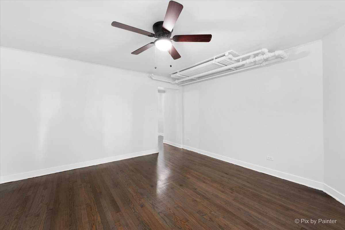 5428 North Campbell Avenue, Unit GS Chicago, IL 60625 - Photo 3 of 14 a view of a room with wooden floor and ceiling fan