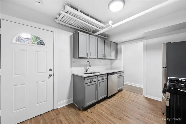 a kitchen with stainless steel appliances granite countertop a stove and a refrigerator