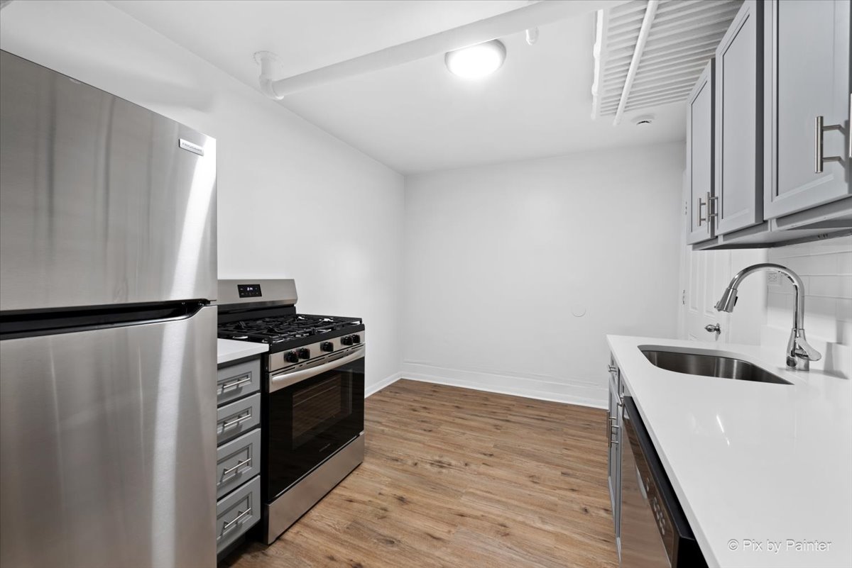 5428 North Campbell Avenue, Unit GS Chicago, IL 60625 - Photo 7 of 14 a kitchen with a stove and a refrigerator