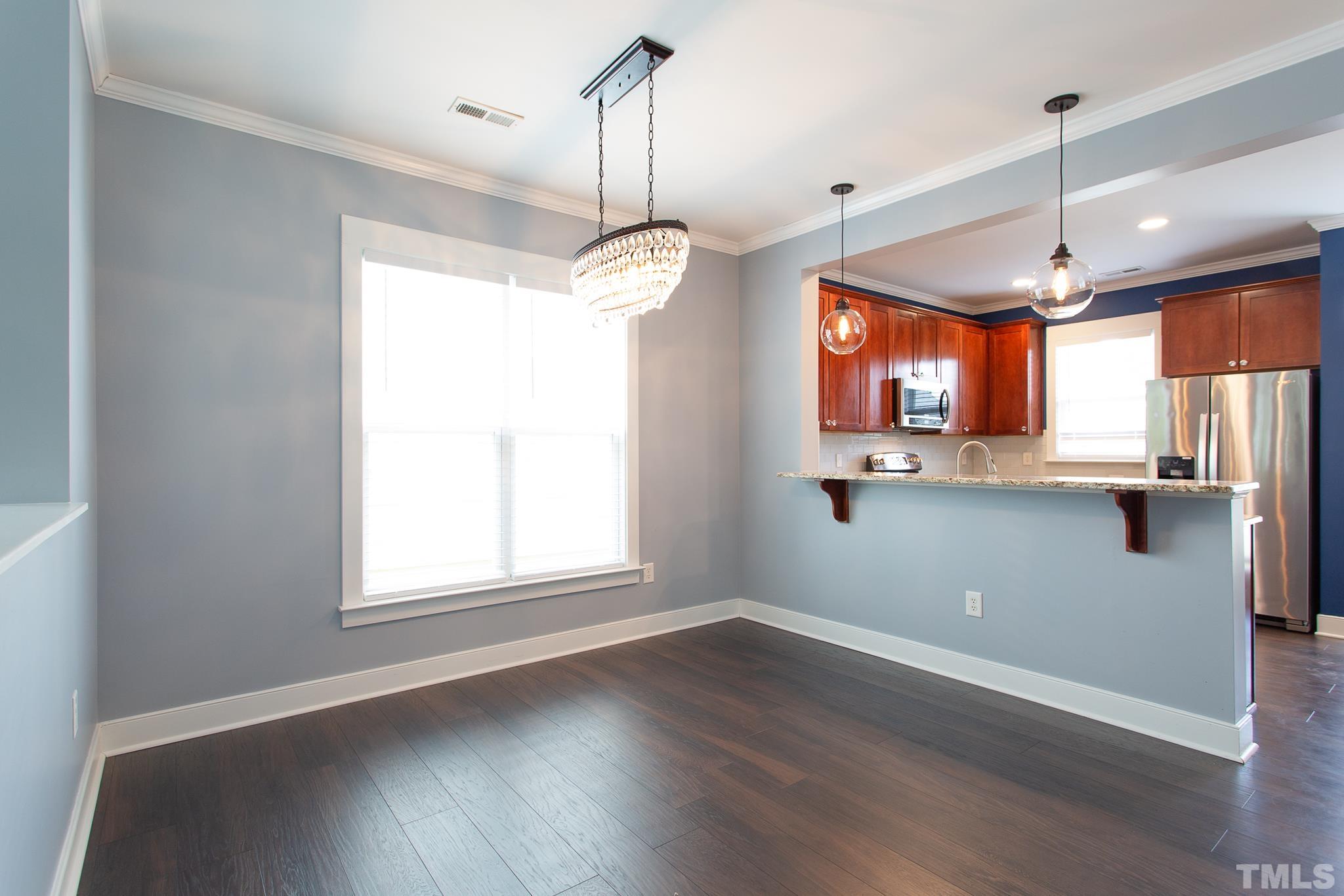 2262 Dunlin Lane Raleigh, NC 27614 - Photo 11 of 27 a view of a kitchen with wooden floor and a window
