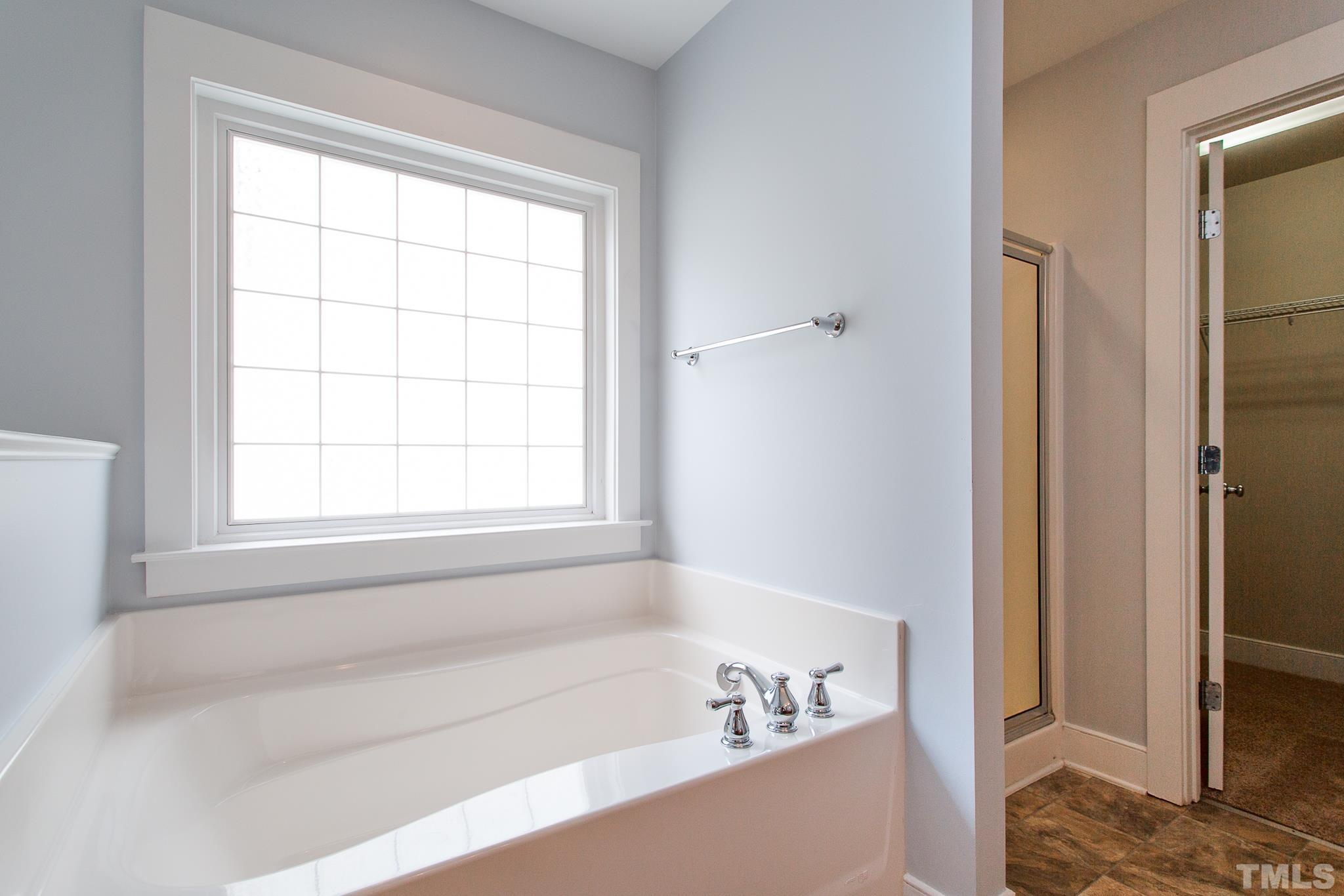 2262 Dunlin Lane Raleigh, NC 27614 - Photo 18 of 27 a white bath tub sitting next to a window