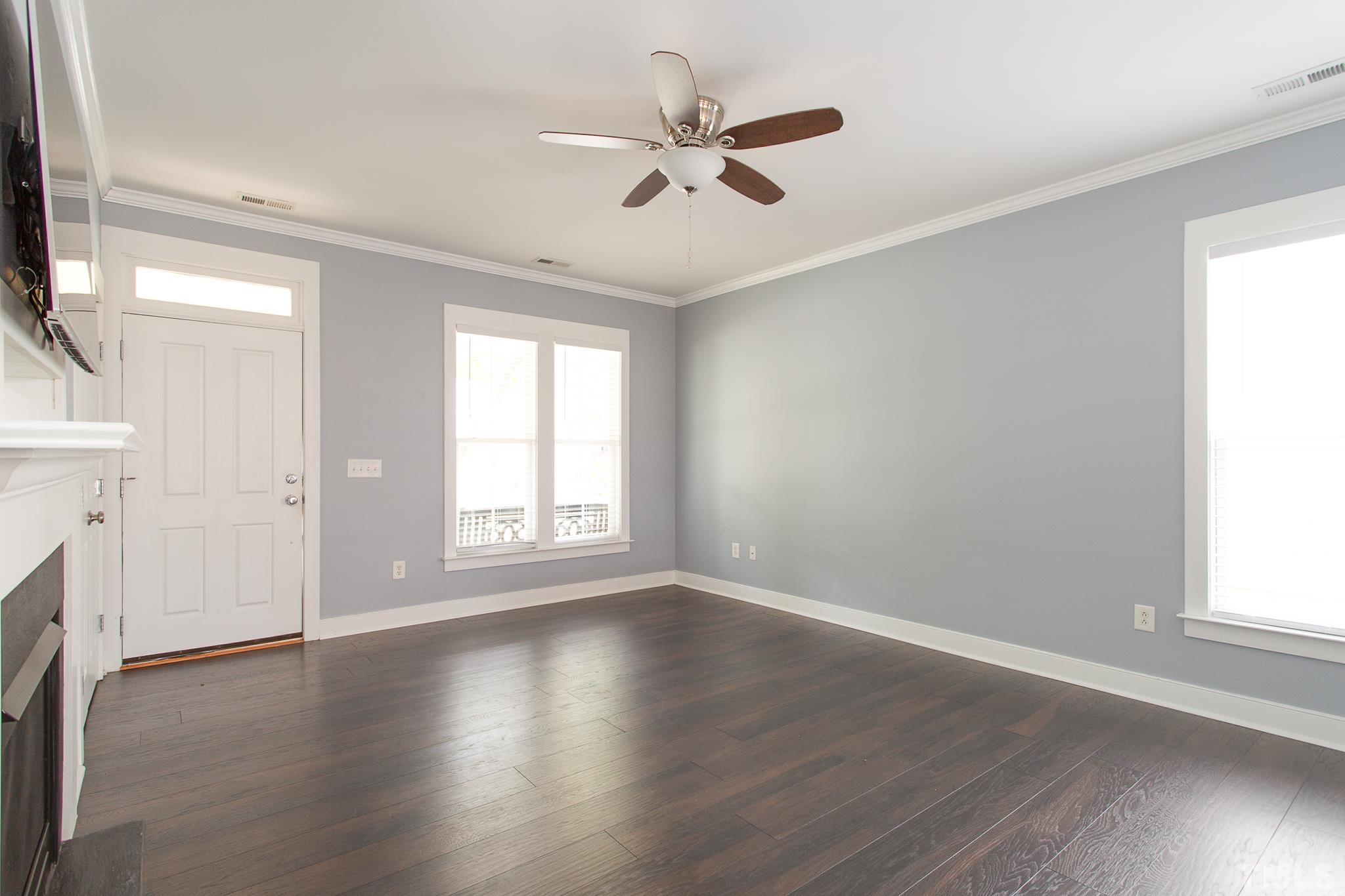 2262 Dunlin Lane Raleigh, NC 27614 - Photo 7 of 27 an empty room with wooden floor fan and windows