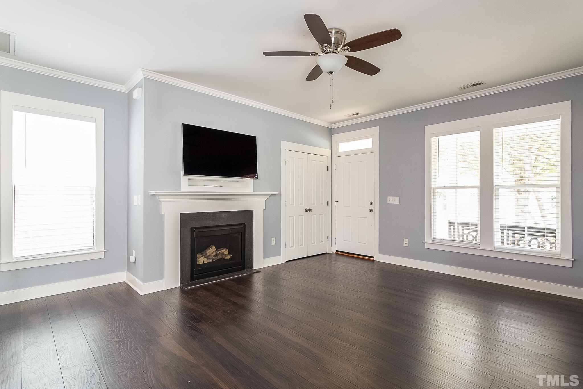 2262 Dunlin Lane Raleigh, NC 27614 - Photo 8 of 27 an empty room with wooden floor fireplace and windows