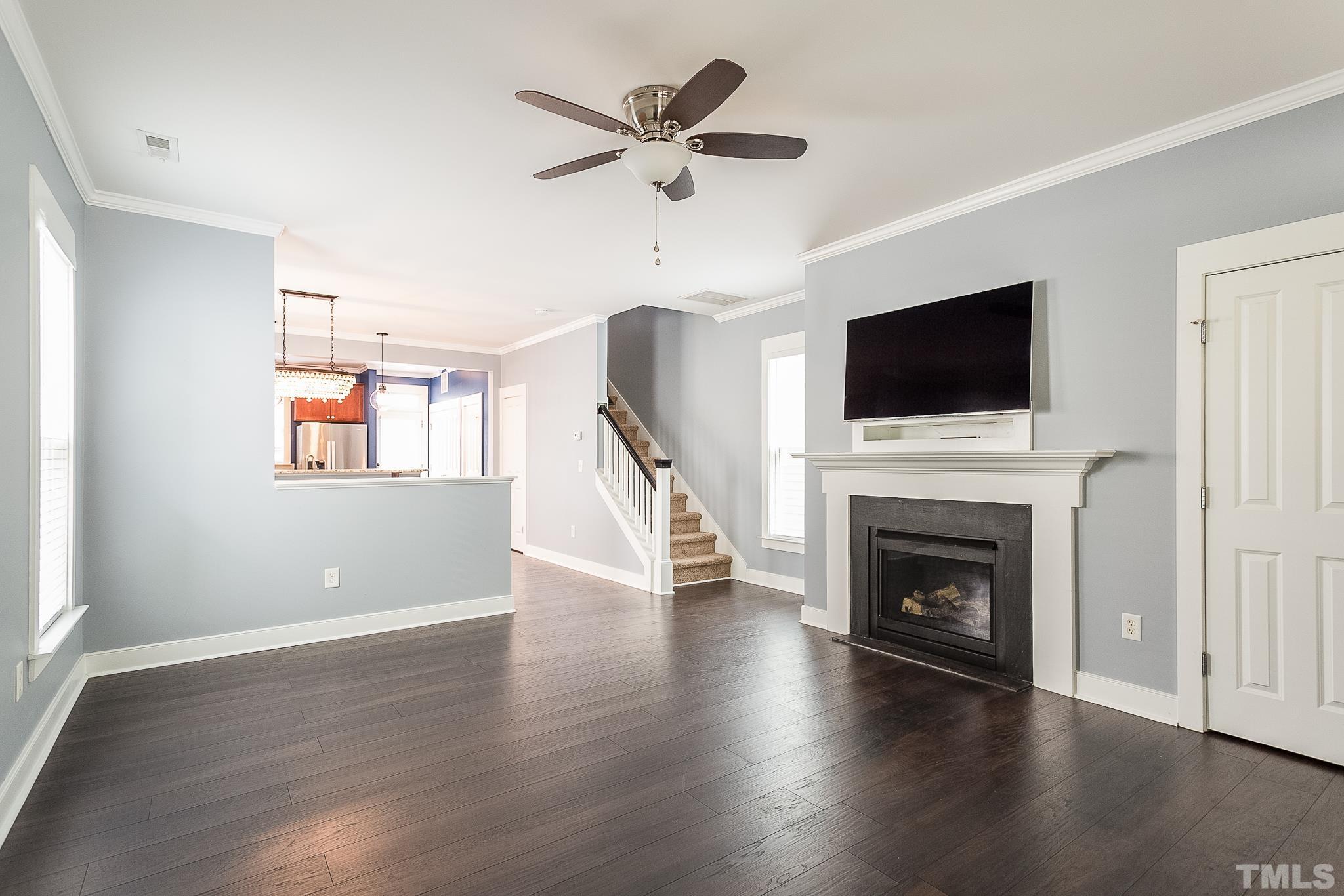 2262 Dunlin Lane Raleigh, NC 27614 - Photo 9 of 27 a living room with wooden floor and a fireplace