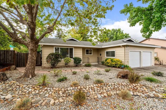 a living room with furniture a rug and a wall painting
