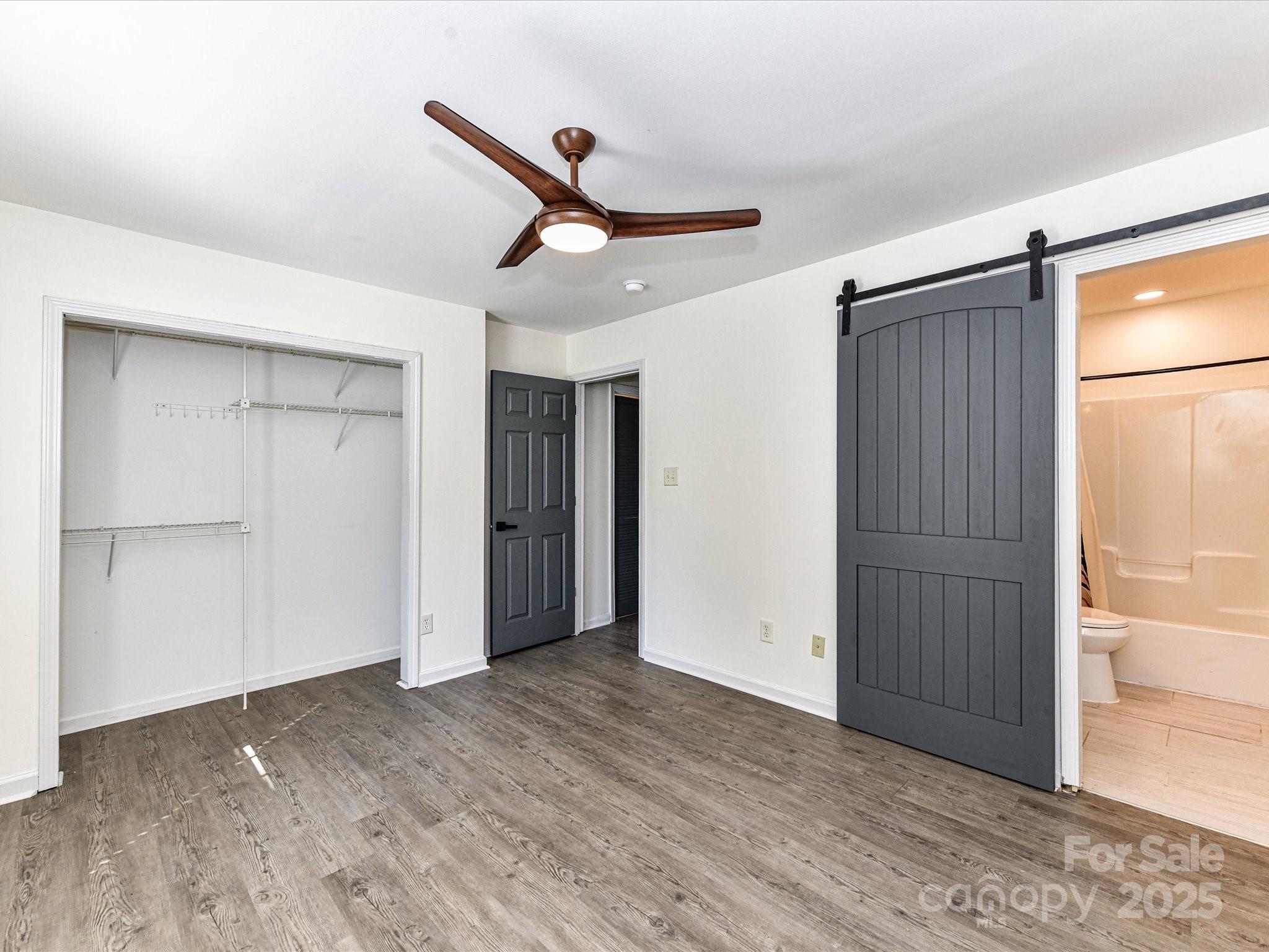 12224 Lullingstone Road Pineville, NC 28134 - Photo 12 of 26 a view of an empty room with wooden floor and a window