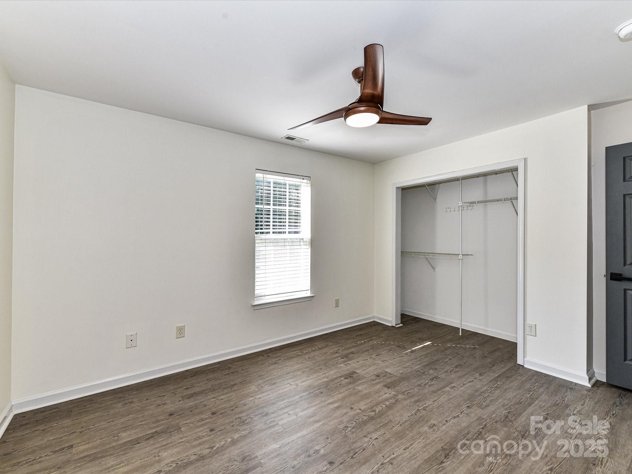 12224 Lullingstone Road Pineville, NC 28134 - Photo 13 of 26 a view of an empty room with a window and wooden floor