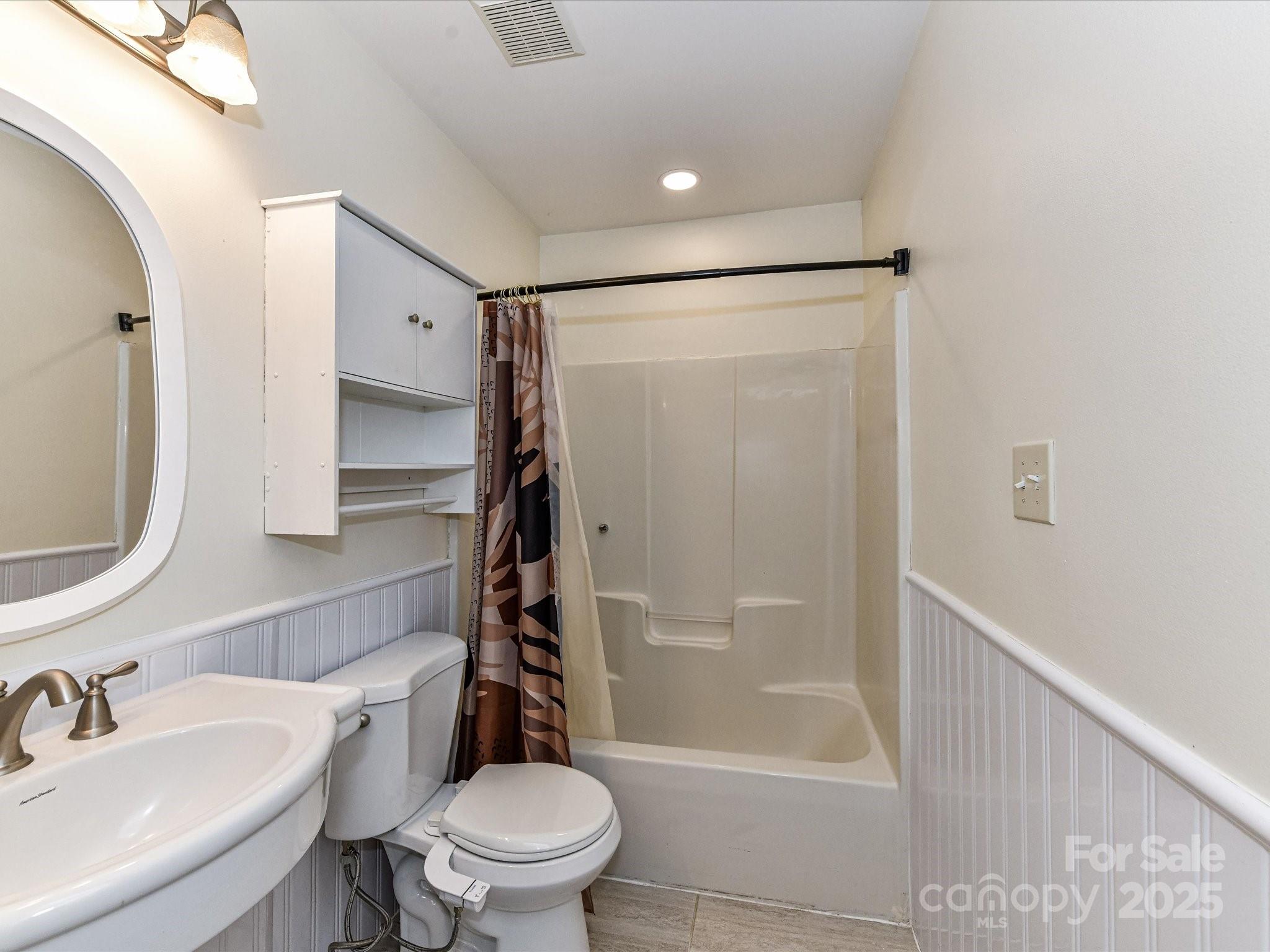 12224 Lullingstone Road Pineville, NC 28134 - Photo 14 of 26 a bathroom with a sink toilet and shower