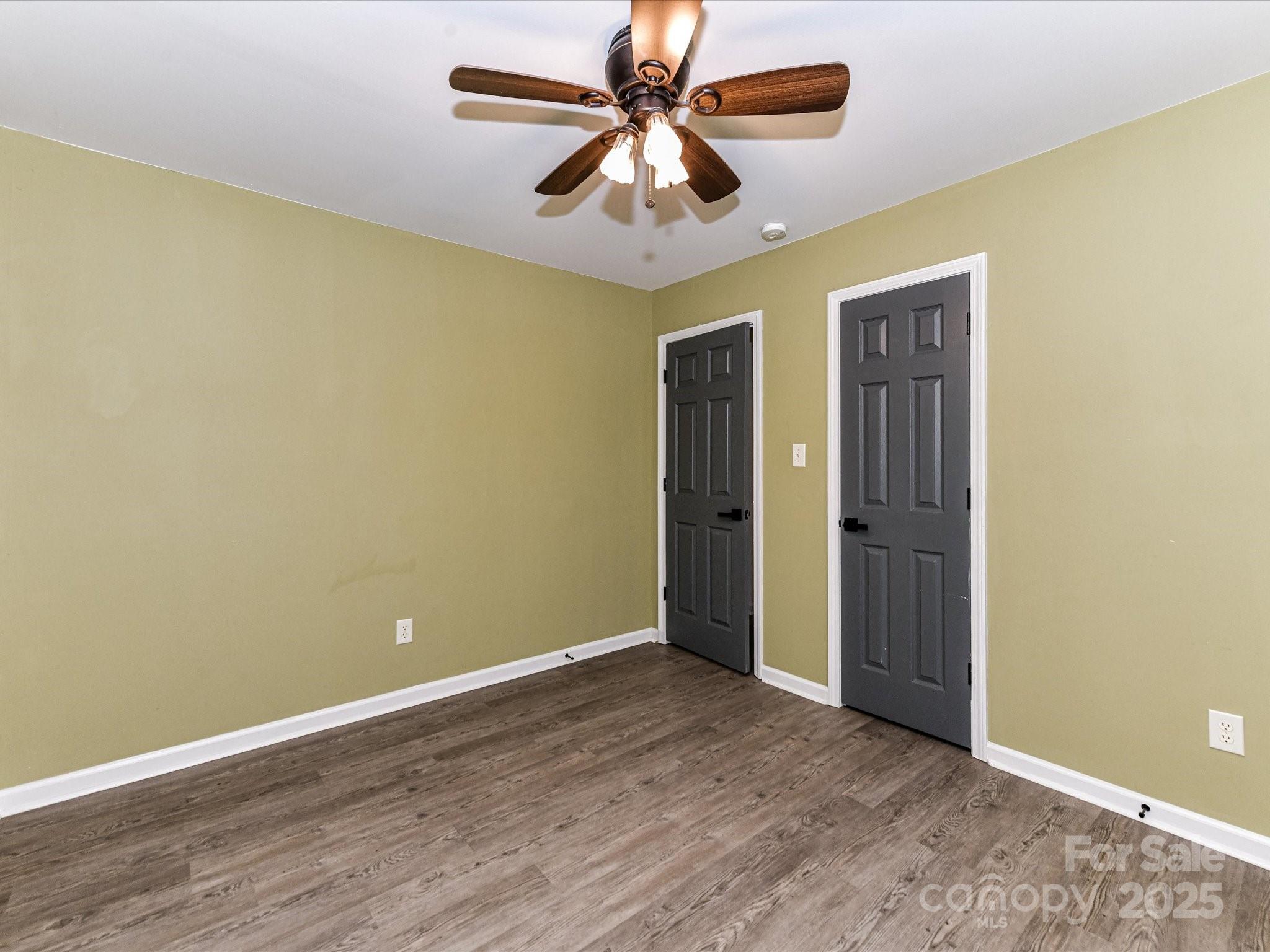 12224 Lullingstone Road Pineville, NC 28134 - Photo 18 of 26 an empty room and chandelier fan