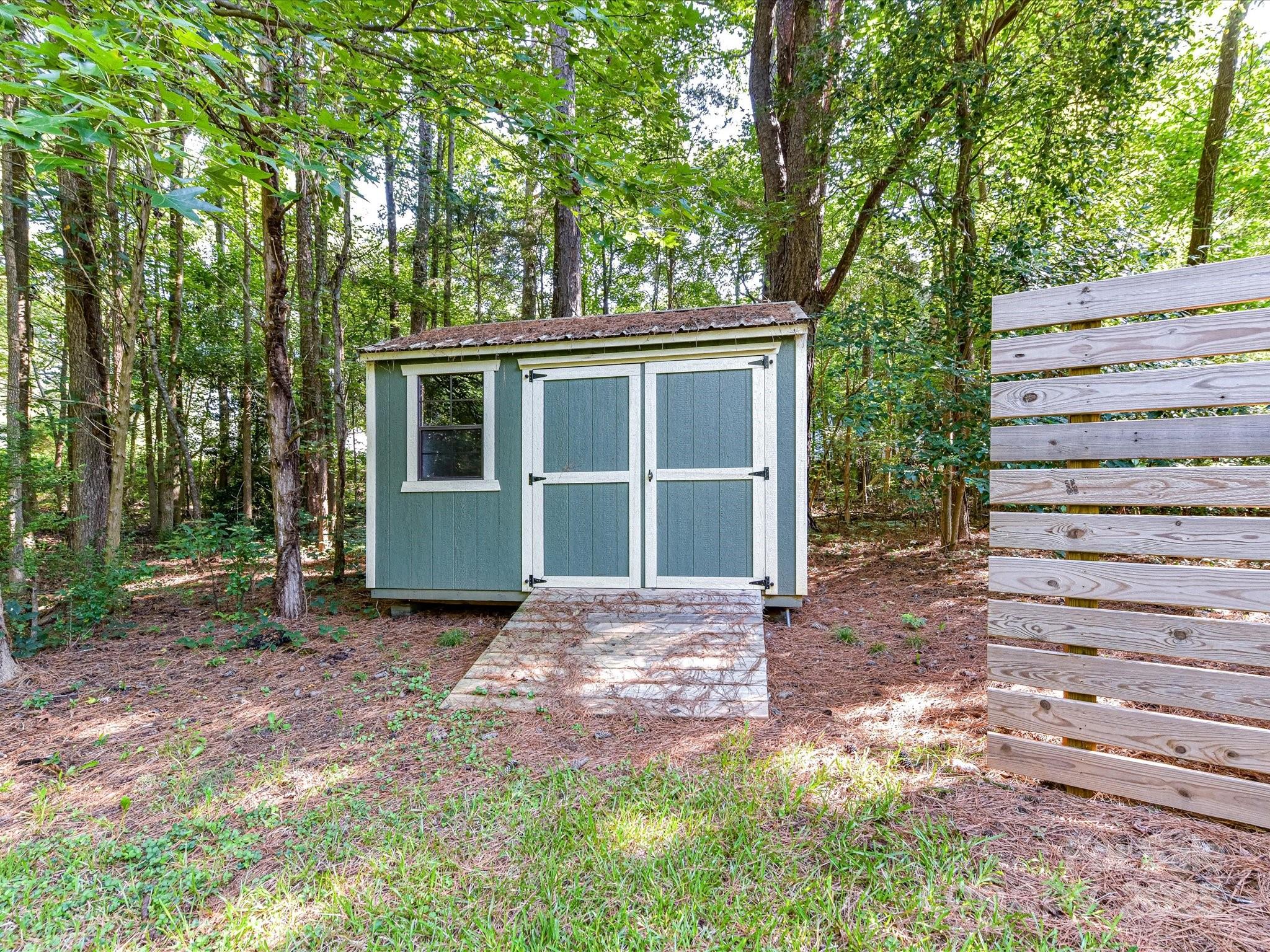 12224 Lullingstone Road Pineville, NC 28134 - Photo 23 of 26 a view of a house with a yard and large tree