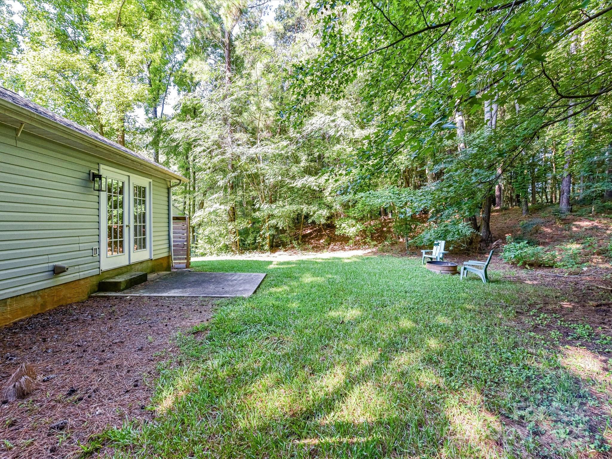 12224 Lullingstone Road Pineville, NC 28134 - Photo 24 of 26 a view of a backyard with plants and large trees