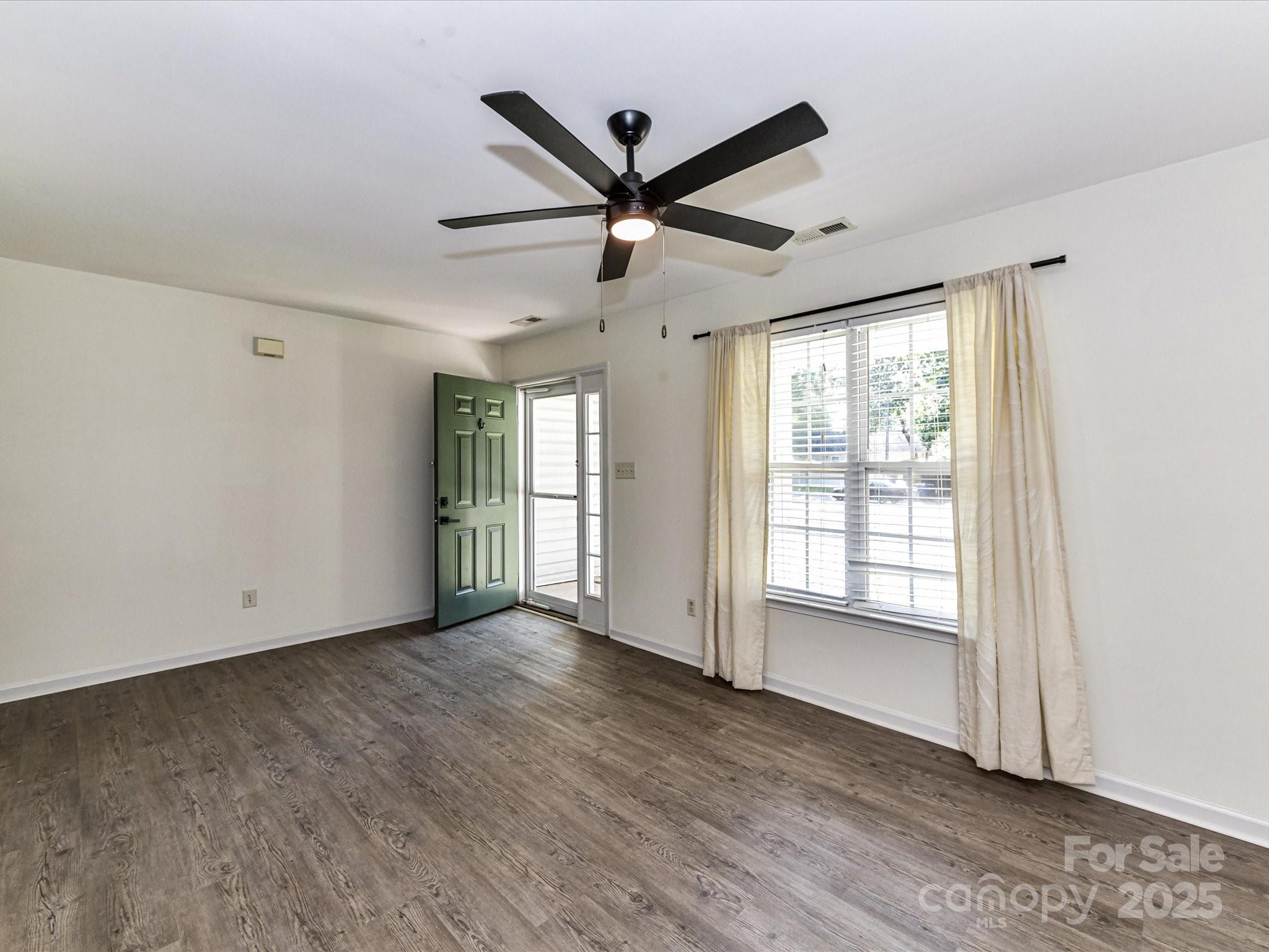 12224 Lullingstone Road Pineville, NC 28134 - Photo 4 of 26 a view of a livingroom with a window and wooden floor