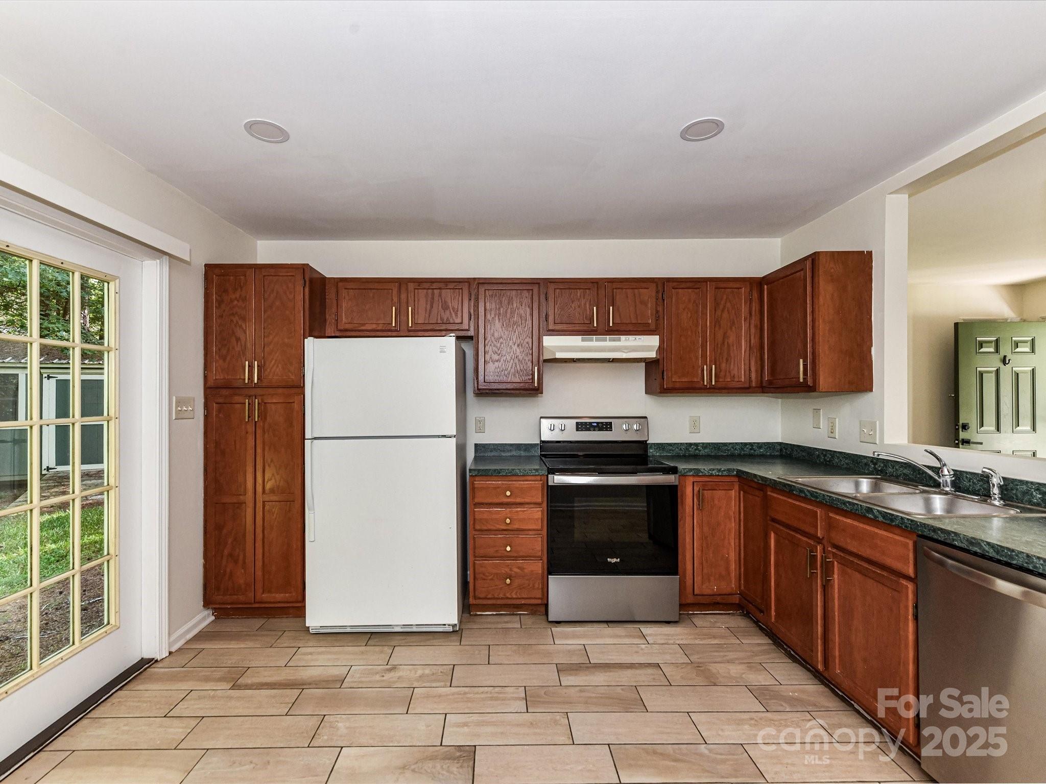 12224 Lullingstone Road Pineville, NC 28134 - Photo 7 of 26 a kitchen with stainless steel appliances granite countertop a refrigerator stove top oven and sink