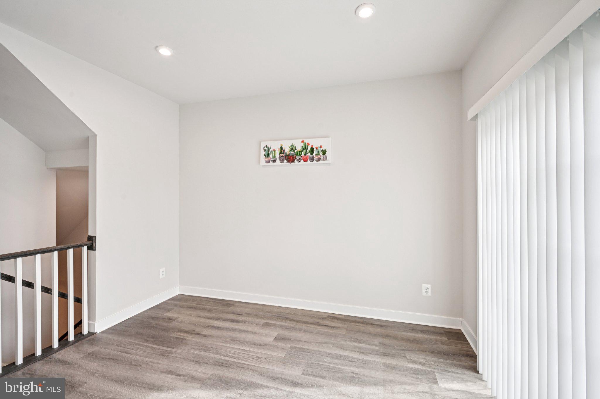 2055 Rivers Drive Newark, DE 19702 - Photo 12 of 32 a view of an empty room with wooden floor and a window