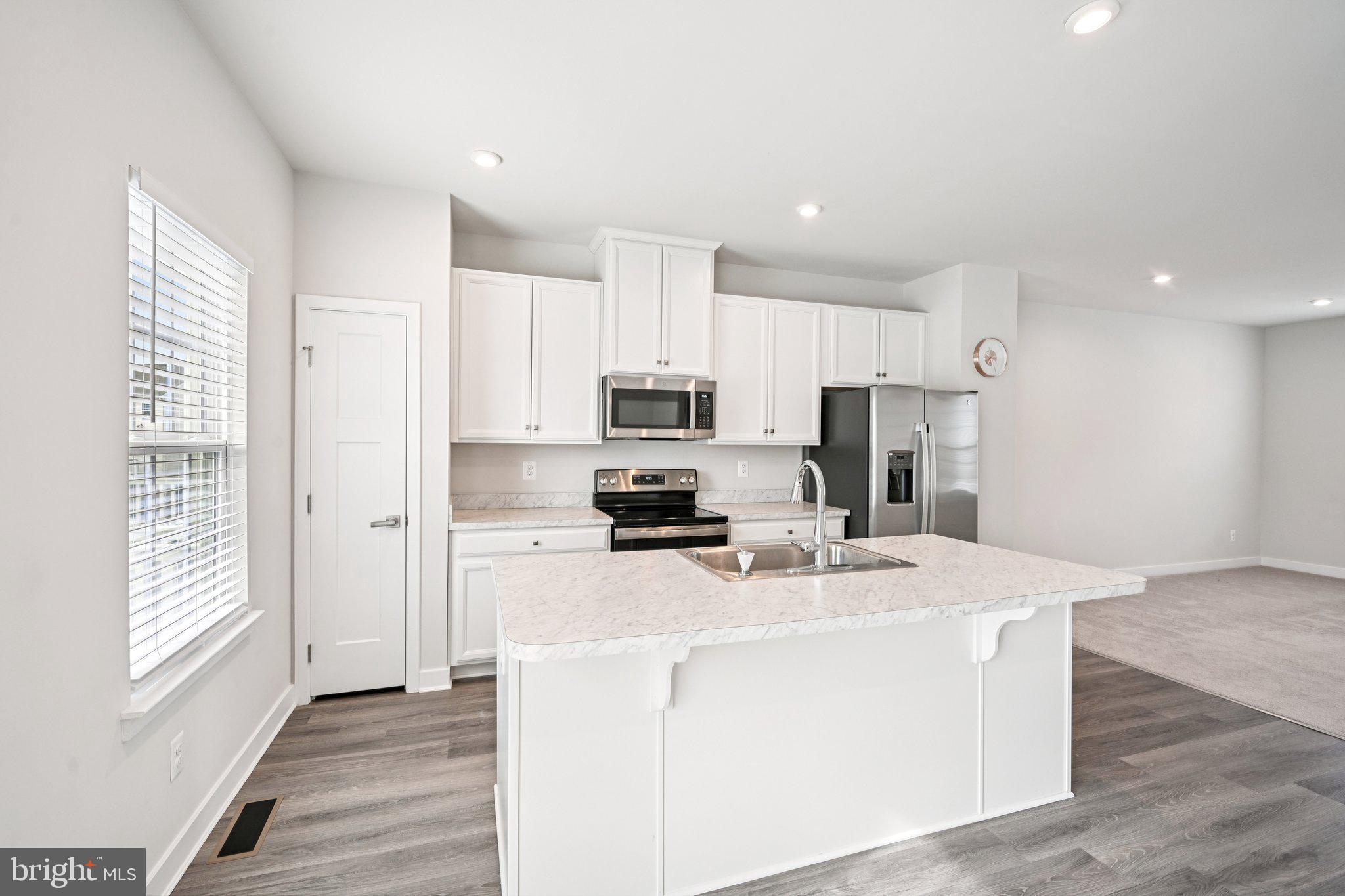 2055 Rivers Drive Newark, DE 19702 - Photo 13 of 32 a kitchen with kitchen island a white counter top space cabinets and stainless steel appliances
