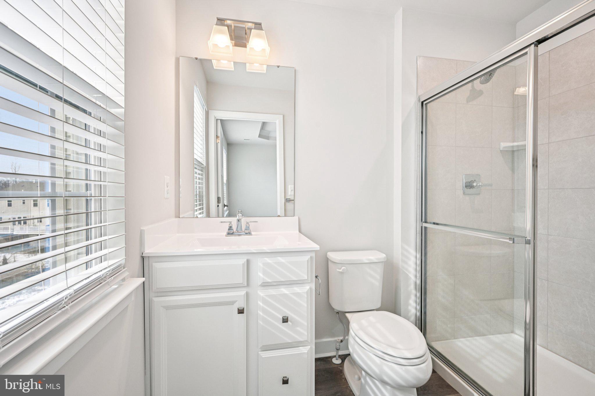2055 Rivers Drive Newark, DE 19702 - Photo 20 of 32 a bathroom with a sink a toilet a mirror and shower