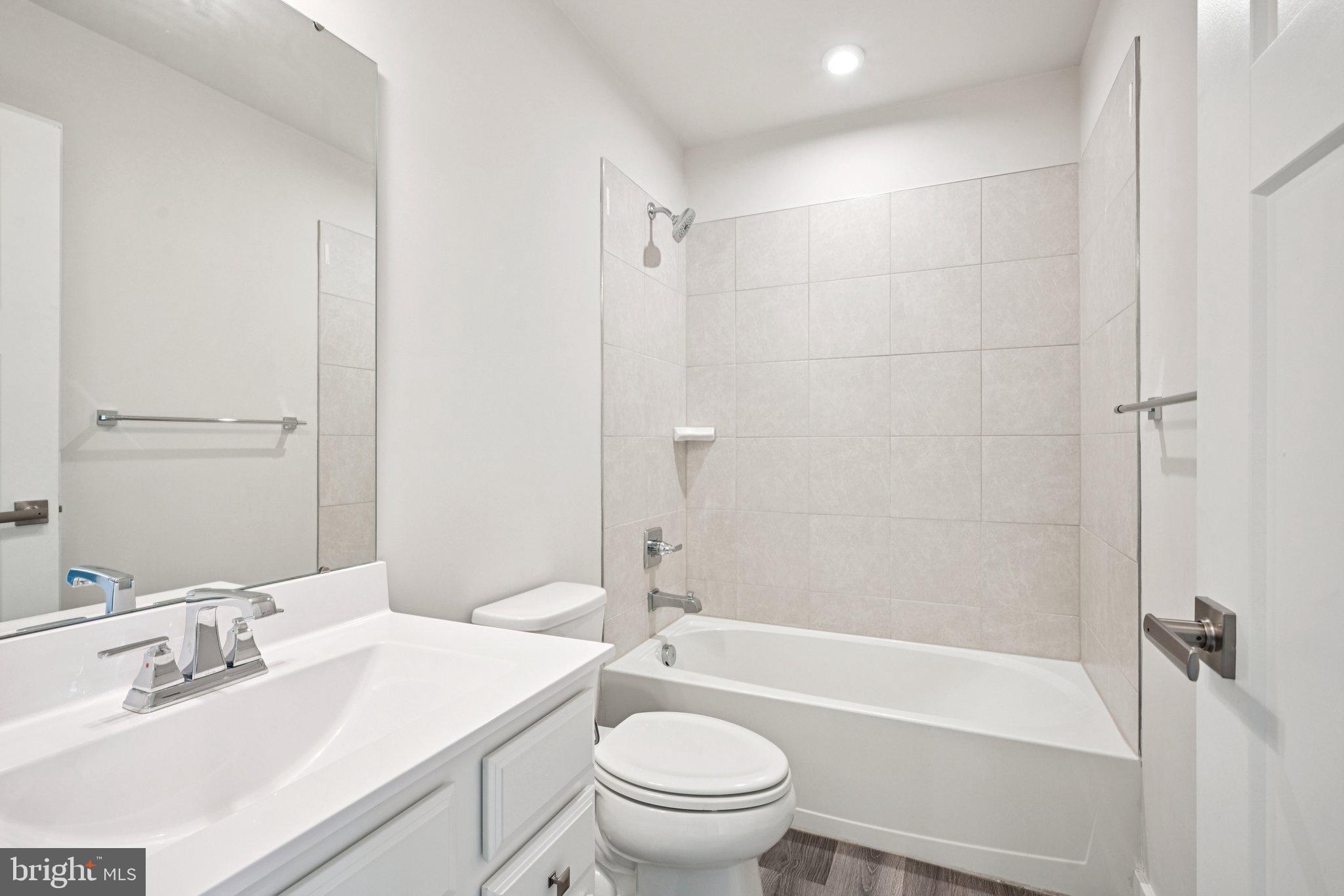2055 Rivers Drive Newark, DE 19702 - Photo 25 of 32 a bathroom with a bathtub shower sink vanity mirror and toilet