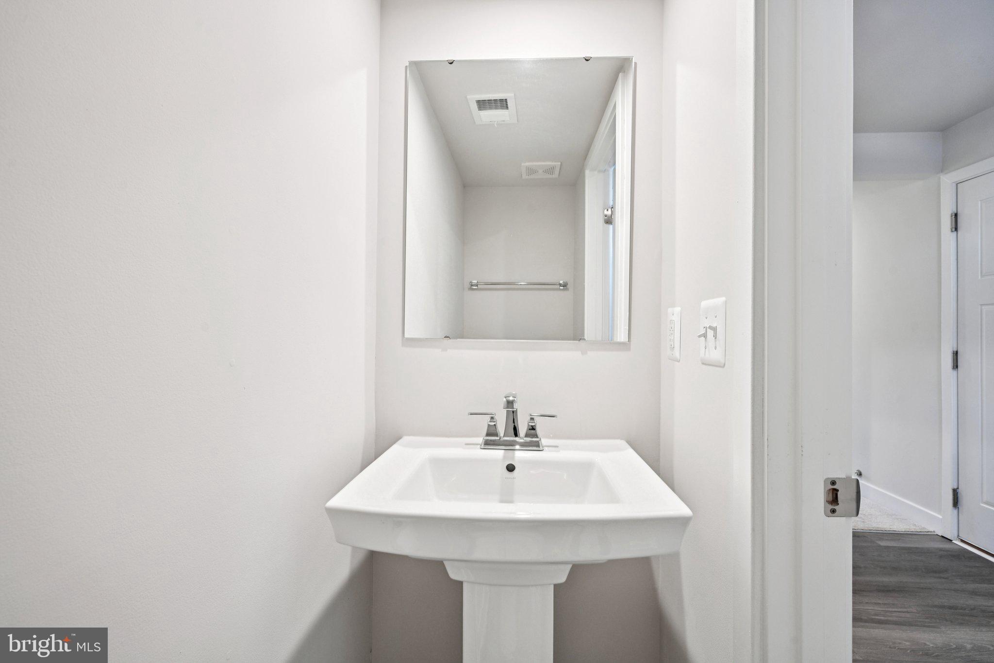2055 Rivers Drive Newark, DE 19702 - Photo 29 of 32 a bathroom with a sink and a mirror