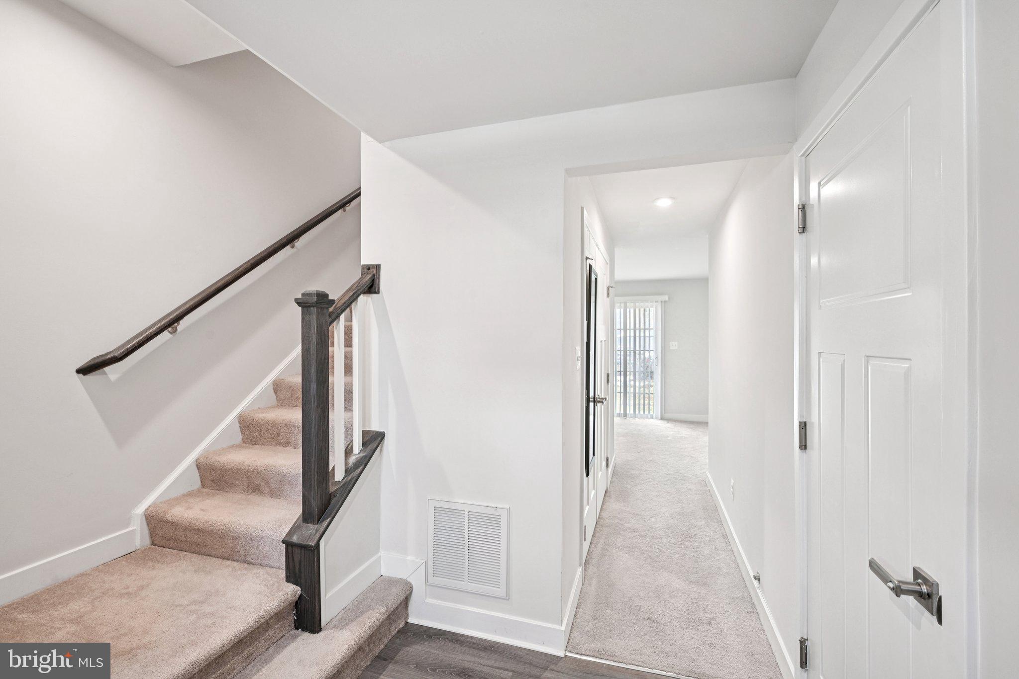 2055 Rivers Drive Newark, DE 19702 - Photo 5 of 32 a view of hallway with stairs and wooden floor