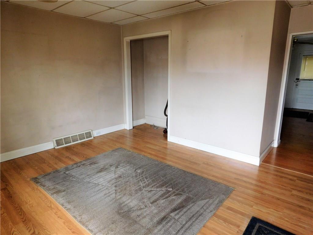 725 School Street McKees Rocks, PA 15136 - Photo 2 of 14 an empty room with wooden floor