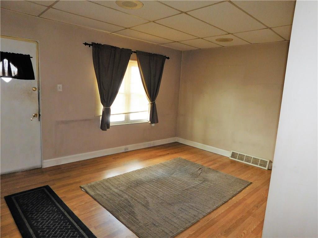 725 School Street McKees Rocks, PA 15136 - Photo 3 of 14 an empty room with wooden floor and windows