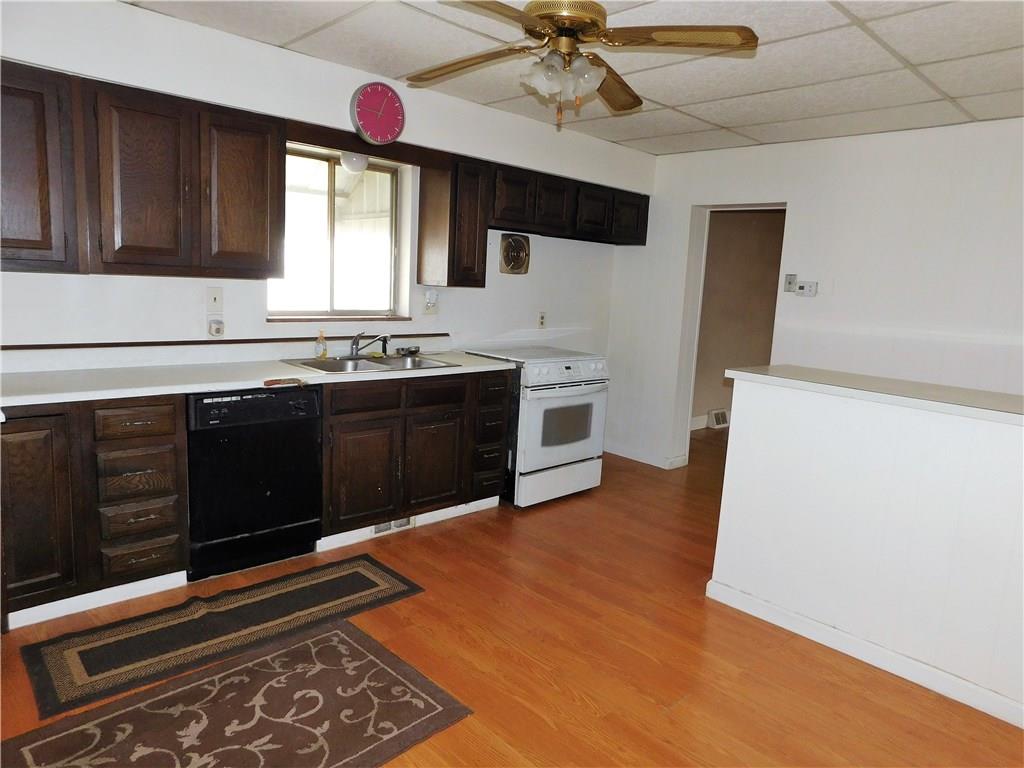 725 School Street McKees Rocks, PA 15136 - Photo 4 of 14 a kitchen with stainless steel appliances granite countertop a sink and a stove