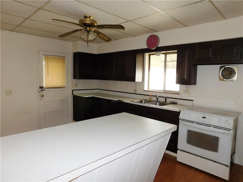 725 School Street McKees Rocks, PA 15136 - Photo 5 of 14 a kitchen with a stove and a microwave