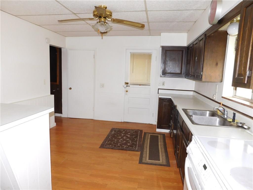 725 School Street McKees Rocks, PA 15136 - Photo 6 of 14 a kitchen with kitchen island a counter top space a sink and appliances