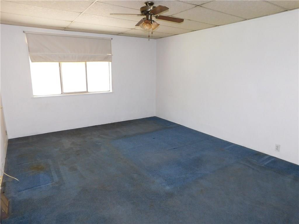 725 School Street McKees Rocks, PA 15136 - Photo 8 of 14 an empty room with a ceiling fan and window