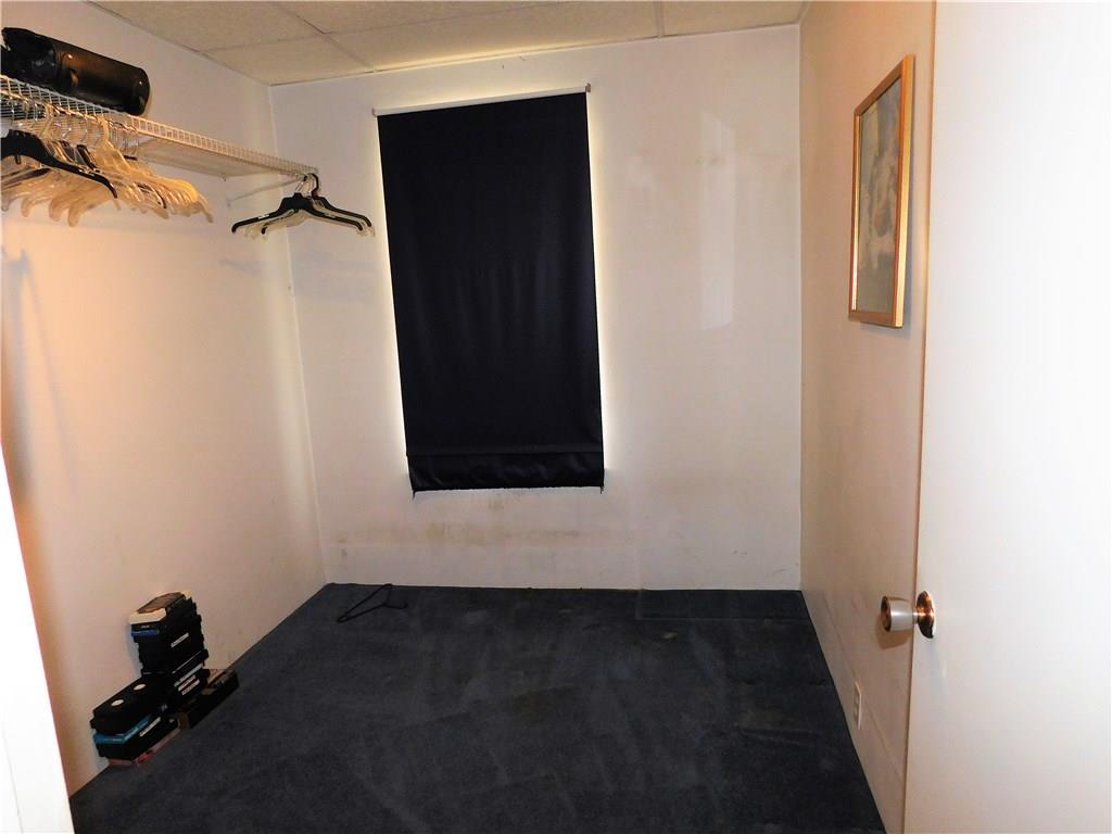 725 School Street McKees Rocks, PA 15136 - Photo 9 of 14 a view of walk in closet with clothes and shoes