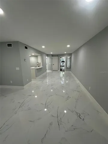 a view of a kitchen with a sink and cabinets