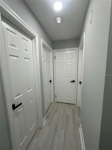 a view of an empty room with wooden floor