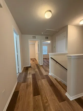 a view of a room with wooden floor