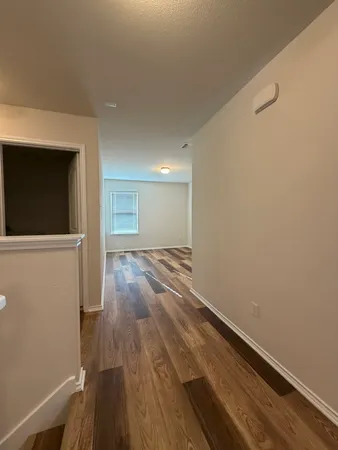a view of wooden floor in an empty room