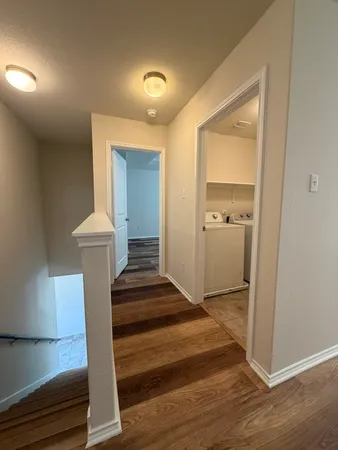 a view of entryway and hall with wooden floor
